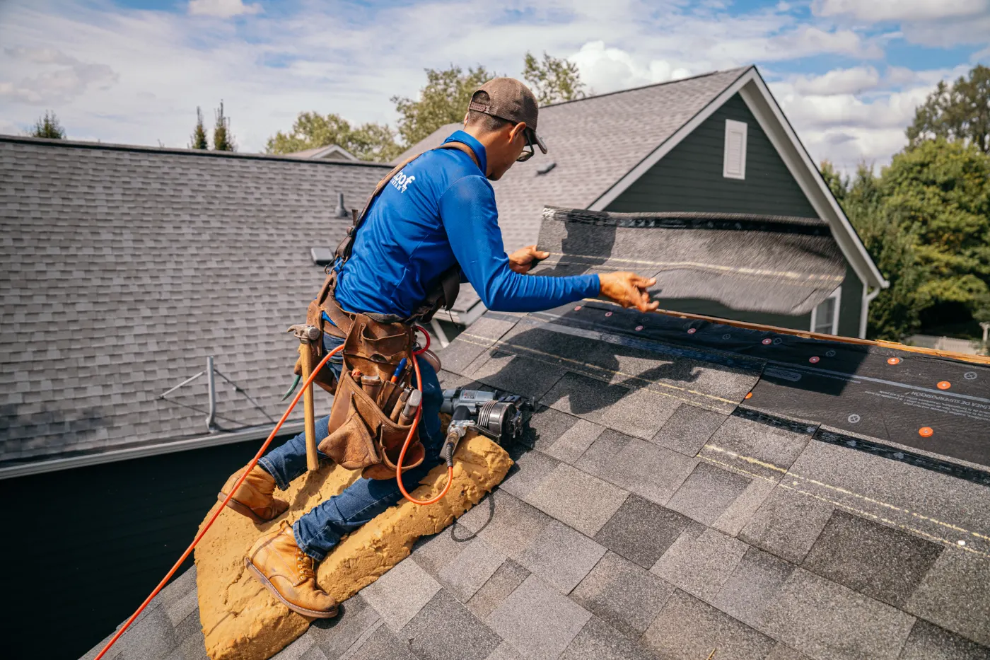 Tarping and dry-in on a Woodcreek Crossing commercial roof